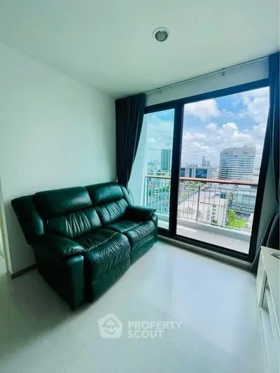 Modern living room with city view and sleek black leather sofa