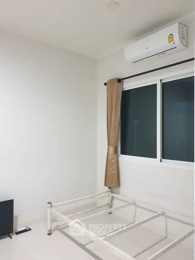 Minimalist bedroom with air conditioning and window, ready for customization.