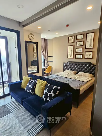 Modern studio apartment with stylish decor and balcony view