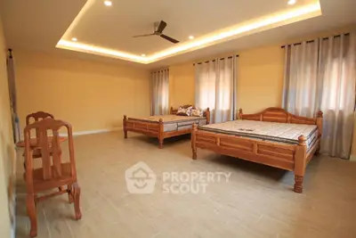 Spacious bedroom with twin beds and elegant lighting, perfect for comfort and relaxation.