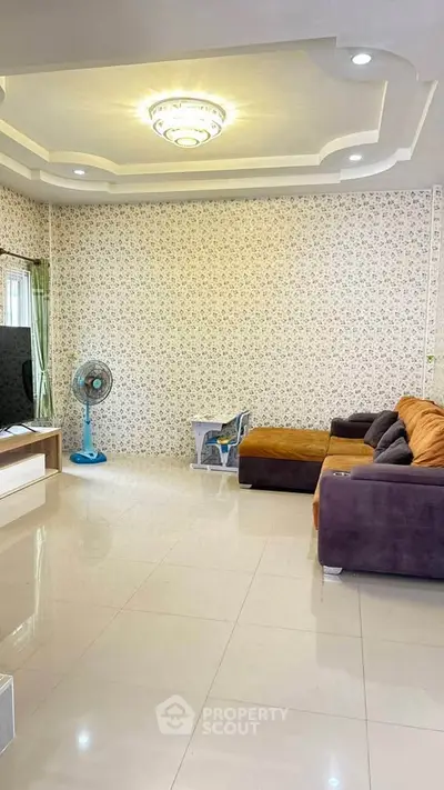 Spacious living room with modern ceiling design and cozy sectional sofa