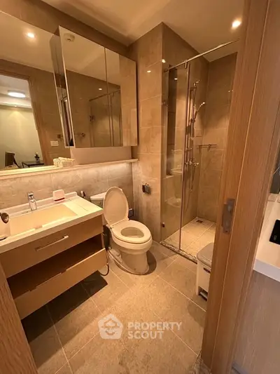 Modern bathroom with glass shower and elegant fixtures in a stylish apartment.