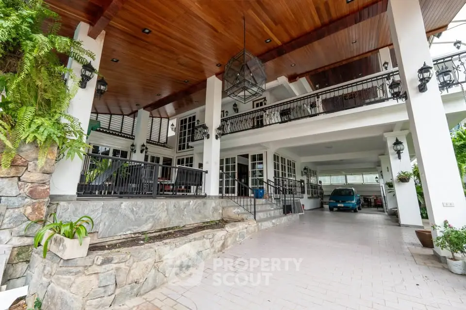 Stunning modern home exterior with spacious driveway and elegant wooden ceiling.