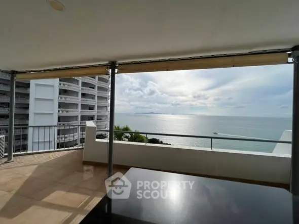 Stunning ocean view from a spacious balcony in a modern apartment building.