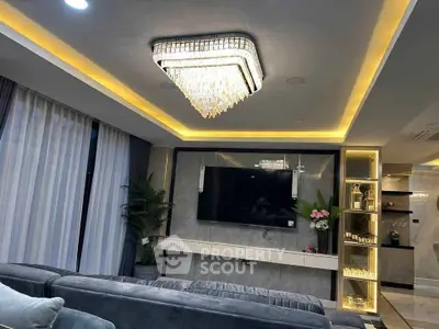 Luxurious living room with modern chandelier and elegant decor