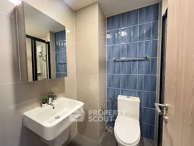 Modern bathroom with sleek design and blue tile accent wall