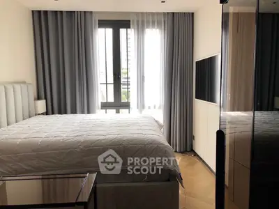 Modern bedroom with large window and stylish decor