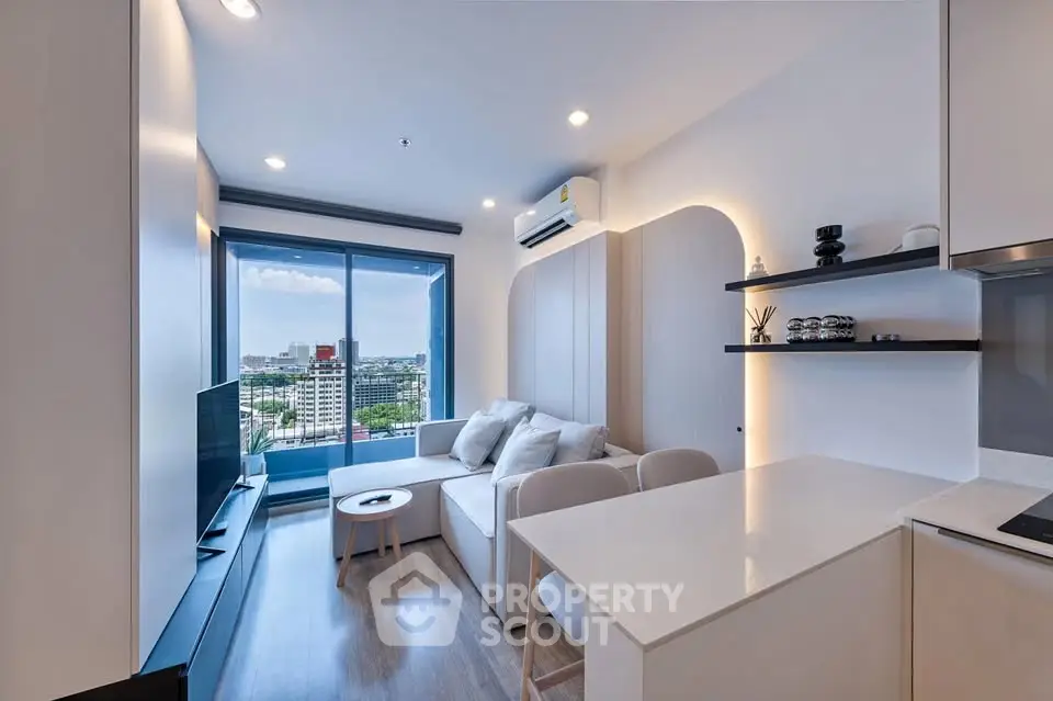 Modern living room with city view, sleek furniture, and open layout in a high-rise apartment.