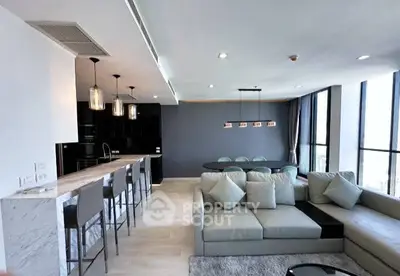 Spacious modern living room with open kitchen and panoramic windows