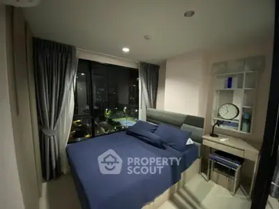 Cozy bedroom with city view, modern furnishings, and ample natural light for a serene living experience.