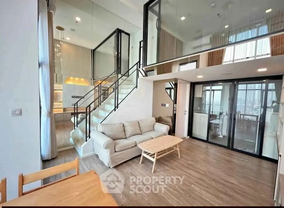 Spacious modern living room with mezzanine and elegant staircase
