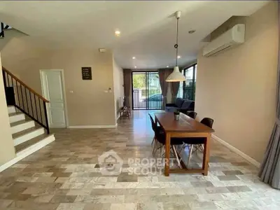 Spacious modern living room with dining area and large windows