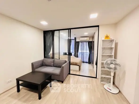 Modern living room with glass partition and cozy furniture in stylish apartment