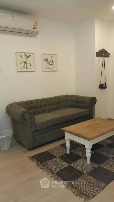 Cozy living room with stylish sofa and wooden coffee table, perfect for relaxation.