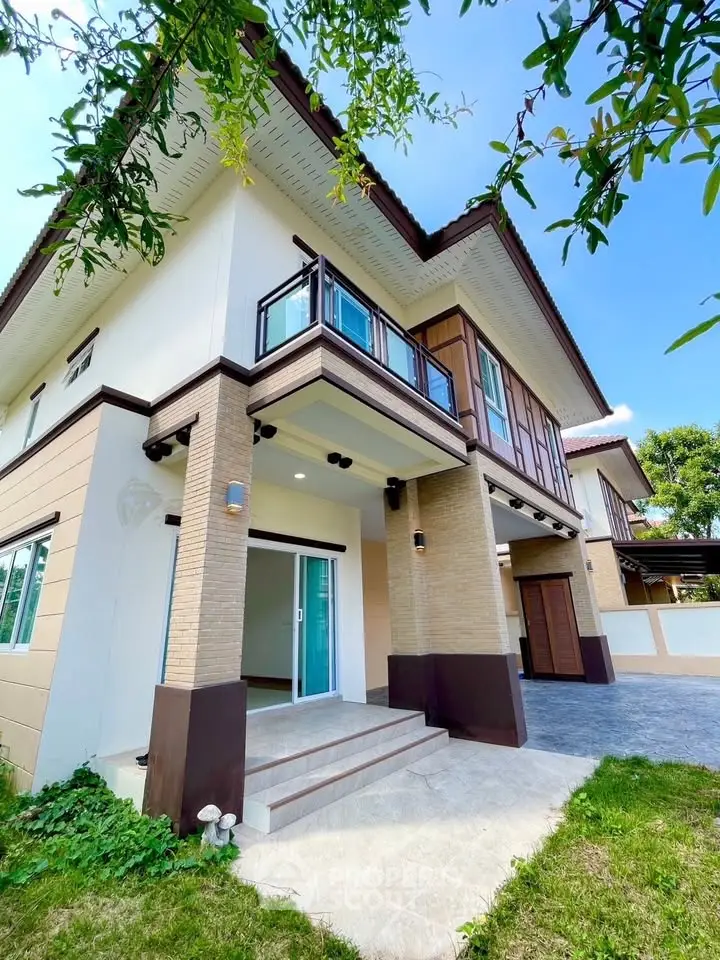 Stunning modern two-story house with elegant balcony and lush greenery