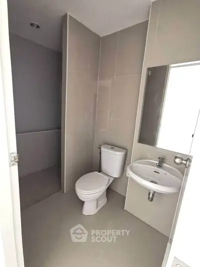 Modern bathroom with sleek fixtures and neutral tiles, perfect for a contemporary home.