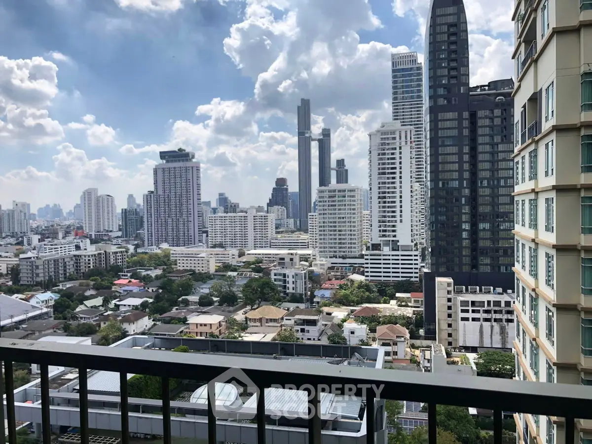 Stunning cityscape view from a high-rise balcony overlooking urban skyline and skyscrapers.