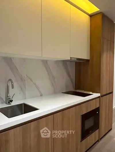 Modern kitchen with sleek cabinetry and built-in appliances