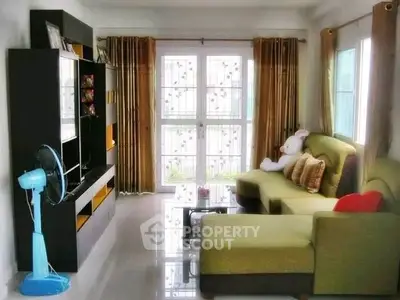 Charming living room with modern furniture and natural light, perfect for relaxation and entertainment.