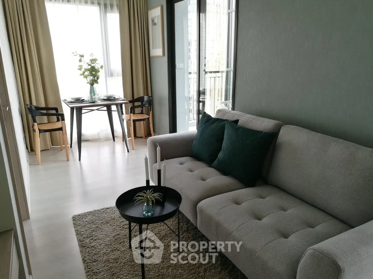 Modern living room with cozy sofa and dining area near balcony