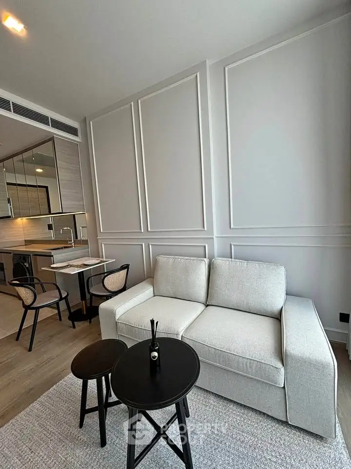 Modern living room with elegant panel walls and cozy furniture in a stylish apartment.