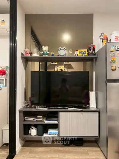 Cozy living room with modern TV setup and stylish shelving