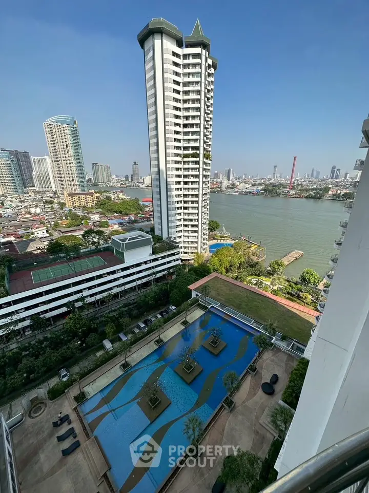 Stunning high-rise building with river view and luxurious pool area in vibrant cityscape.
