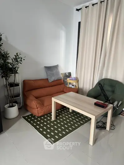 Cozy living room corner with modern chairs and table, ideal for relaxation.