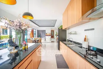 Luxurious open-layout kitchen with modern appliances and elegant dining area, perfect for entertaining.