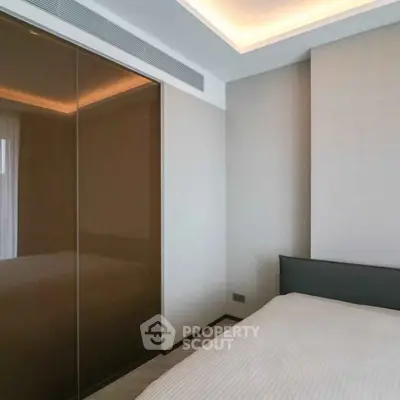 Modern bedroom with sleek design and ambient lighting