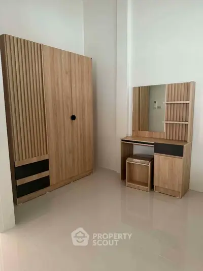 Modern bedroom with sleek wooden wardrobe and matching vanity set