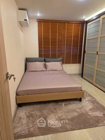 Cozy bedroom with modern decor and ample natural light