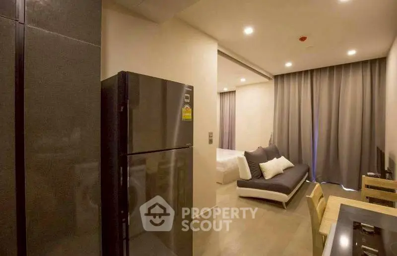 Modern studio apartment with sleek kitchen and cozy living area