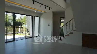 Spacious modern living room with large windows and garden view