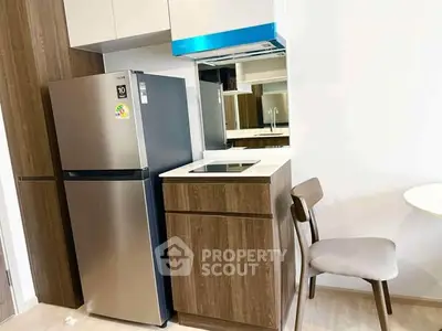 Modern kitchen with sleek appliances and stylish cabinetry in a compact layout.