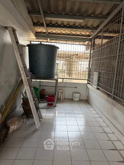 Spacious tiled balcony with storage potential and natural light.