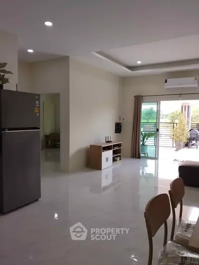 Spacious living room with modern decor and balcony view