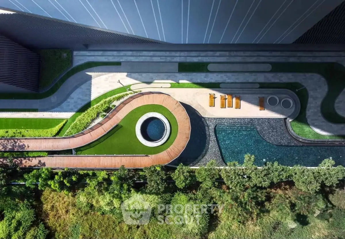 Stunning aerial view of modern landscaped garden with pool and seating area.