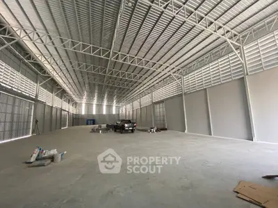Spacious industrial warehouse with high ceilings and ample storage space.