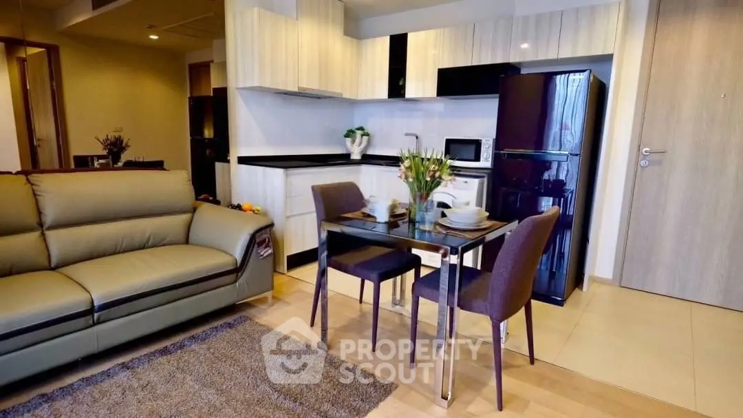 Modern open-layout living room and kitchen with stylish furniture and appliances