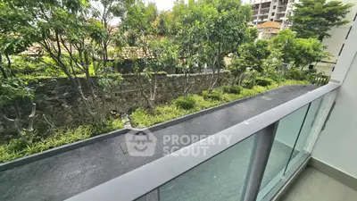 Charming balcony view with lush greenery and modern glass railing.