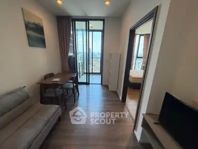 Modern apartment with cozy living room and balcony offering stunning city views.