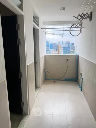 Urban apartment balcony with city view and laundry area