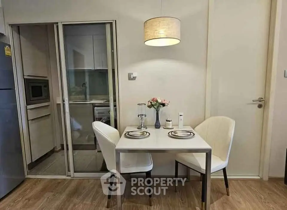 Cozy dining area with modern decor and sliding glass kitchen door.