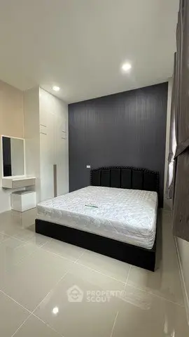 Modern bedroom with sleek design and ample storage in a stylish apartment.