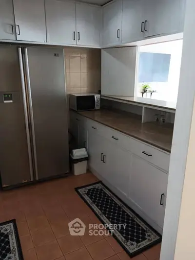 Charming kitchen with ample cabinetry and modern appliances, perfect for culinary enthusiasts.