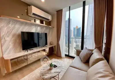 Modern living room with city view, featuring sleek furniture and large windows for natural light.