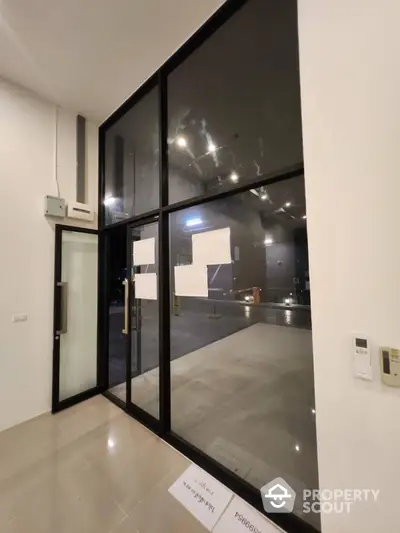 Modern glass entrance with sleek design and spacious interior