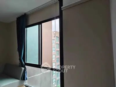 Modern apartment window with city view and stylish curtains