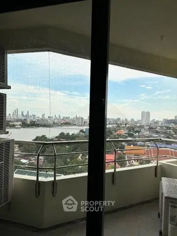 Stunning cityscape view from a high-rise balcony with modern railing.